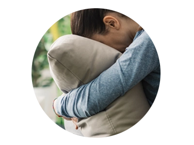 Photo of woman burying face in pillow