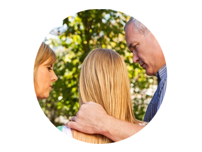 Photo of parents consoling teen daughter